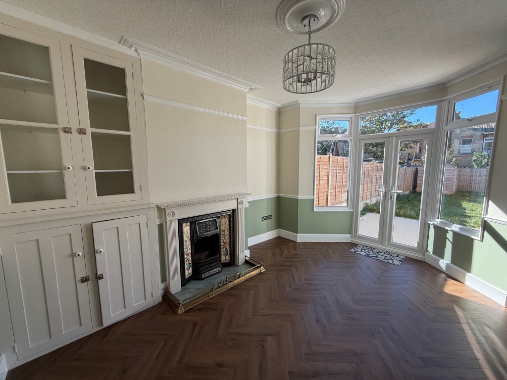 Lot: 132 - THREE-BEDROOM TERRACE HOUSE - Dining Area with fire place and french doors leading to the garden